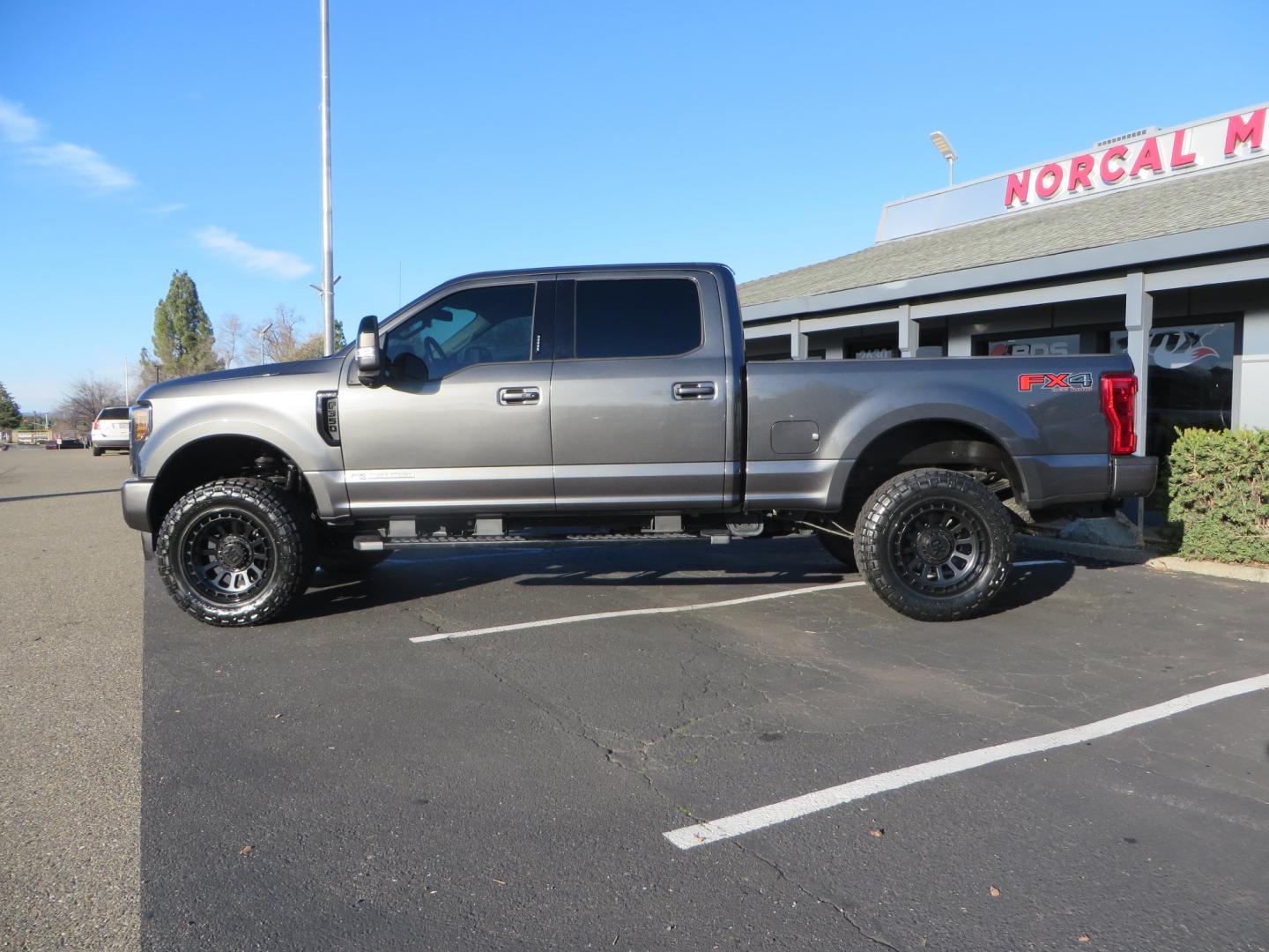 2019 CHARCOAL /BLACK Ford F-350 SD Lariat Crew Cab 4WD (1FT8W3BT7KE) with an 6.7L V8 OHV 16V DIESEL engine, 6A transmission, located at 2630 Grass Valley Highway, Auburn, CA, 95603, (530) 508-5100, 38.937893, -121.095482 - Leveled Superduty sitting on 20" XD series wheels, 35" Nitto Ridge Grappler tires, window tint, and has Firestone Air bags. - Photo#6